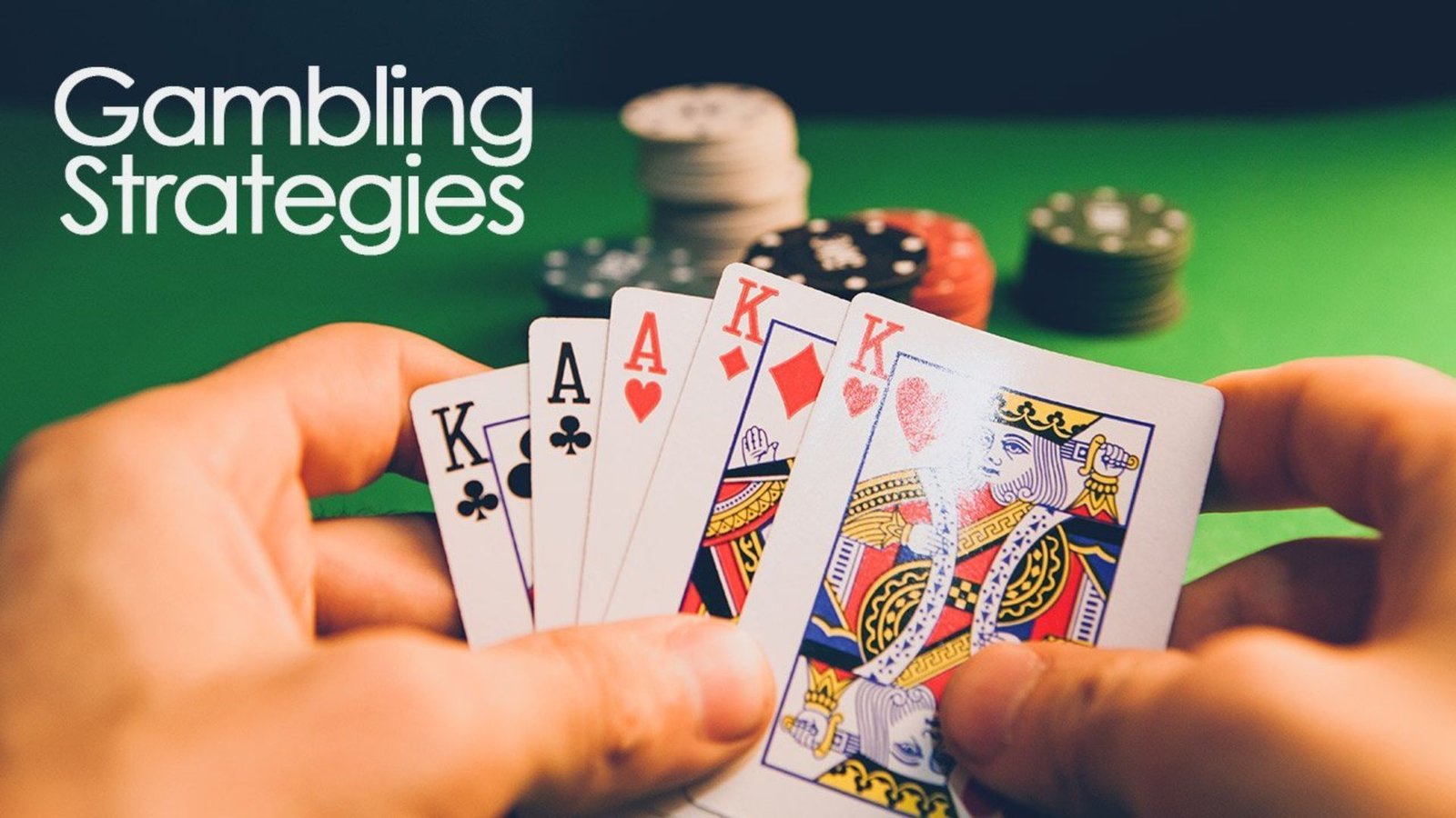 hands holding playing cards showing Strategies for Casino Games